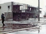 Firemen work to extinguish the blaze that gutted Nanz and Kraft in 1976