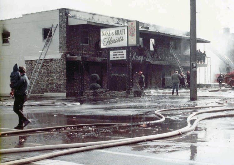 Firemen work to extinguish the blaze that gutted Nanz and Kraft in 1976